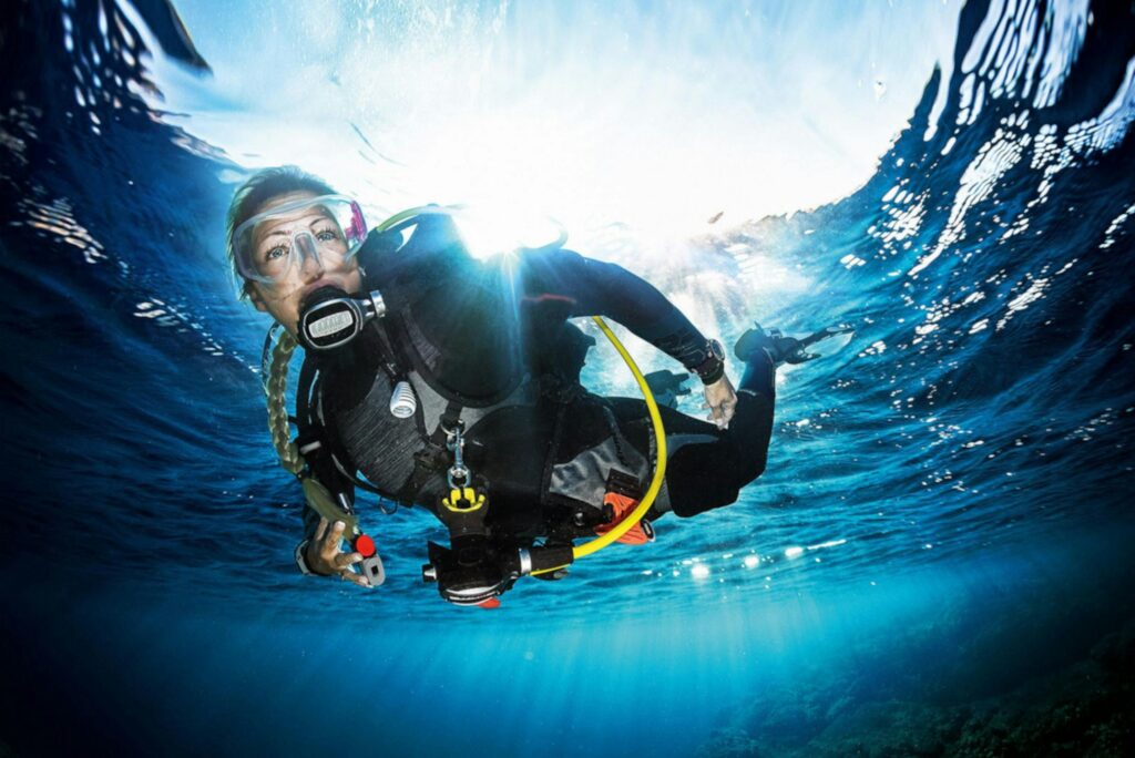 A scuba diver explores the clear blue ocean, capturing the vibrant underwater beauty.